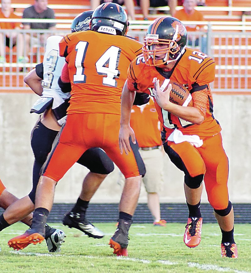 Photo by Randy Moll Gravette&#8217;s quarterback, Bryce Moorman, carries the ball while Gravette senior Jacob Bookout blocks during play against Pottsville on Friday in Gravette.