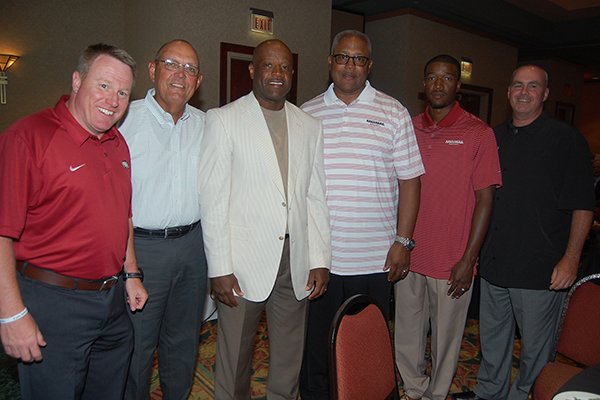 University of Arkansas head basketball coach Mike Anderson (third from left) with assistant coaches Matt Zimmerman, Dave England, Melvin Watkins, T.J. Cleveland, and Jeff Daniels, all of Fayetteville, at the 40th annual Toast and Roast, benefiting Big Brothers Big Sisters of Central Arkansas and honoring Coach Nolan Richardson. The event was held Aug. 21, 2014, in the ballroom of the Embassy Suites in Little Rock.