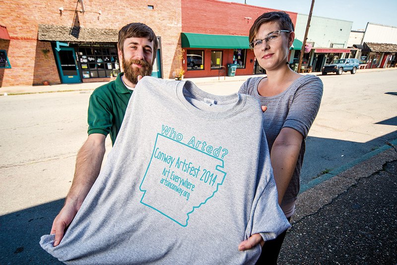 Shawn Goicoechea, left, and Beth Norwood, chairs of Conway ArtsFest 2014, stand on Van Ronkle Street in downtown Conway. The street will be blocked from 5-11 p.m. Oct. 3 for Light Up the Night, which will include art installations, musical performances and more. ArtsFest officially starts Sept. 26 and runs through Oct. 5.