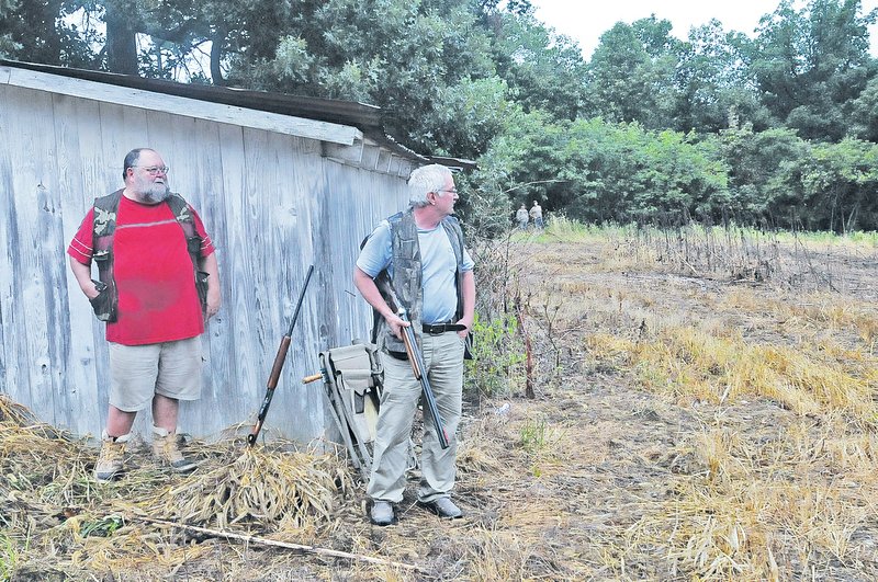 STAFF PHOTO FLIP PUTTHOFF The shooting was slow on opening morning of dove season on Saturday Sept. 6 2014 at a field on the McIlroy Madison County Wildlife Management Area. Erney Precure, left, Jess Eoff and other hunters wait for birds to fly.