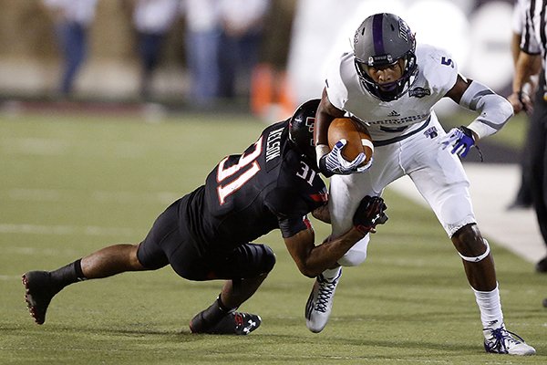 Central Arkansas' Dezmin Lewis is tackled by Texas Tech's Justis Nelson during an NCAA college football game in Lubbock, Texas, Saturday, Aug. 30, 2014. (AP Photo/Lubbock Avalanche-Journal, Tori Eichberger)