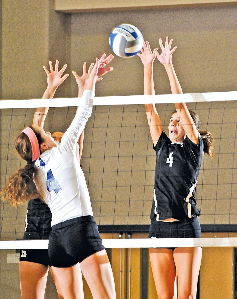  STAFF PHOTO BEN GOFF &#8226; @NWABenGoff Sadie Pate, right, of Bentonville tries to block a spike attempt by Rogers High&#8217;s Shannon Orlopp during Thursday&#8217;s match at Rogers High.