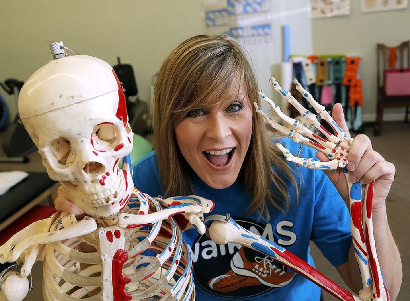 Marla Murphy waves an invitation to “A Vintage Affair for MS” with the bony help of “Mary Kay.” The color-coded replica skeleton — red and blue show where the muscles go — was Murphy’s study mate when she was learning to become a doctor of physical therapy.