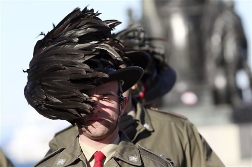 In this Nov. 26, 2013 file photo, the feathered hat of an Italian Bersagliere is blown by a strong wind as he stands at attention before the meeting in Trieste, Italy. In a personal moment, during a commemoration ceremony on Saturday, Sept. 13, 2014, the parents of an Italian soldier killed in Afghanistan last year will present Pope Francis with the distinctive feathered Bersagliere cap worn by the Piemontese corps famed for their endurance. 
