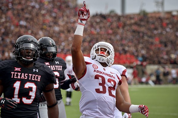 Arkansas running back Jonathan Williams celebrates after scoring his second touchdown in the first quarter of the game at Jones AT&T Stadium in Lubbock, Texas on Saturday Sept. 13, 2014. 