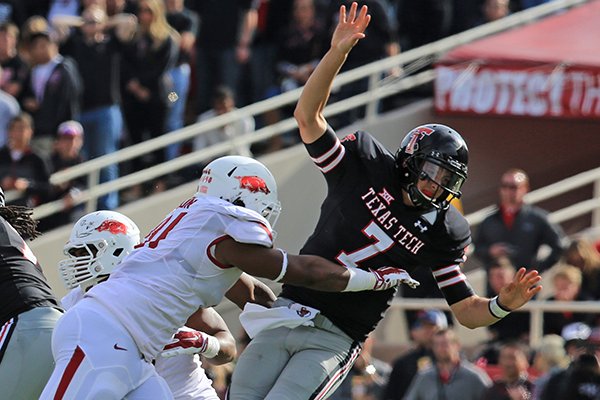 Arkansas defensive tackle Darius Philon hits Texas Tech quarterback David Webb in the fourth quarter of a game at Jones AT&T Stadium in Lubbock, Texas on Saturday on Sept. 13, 2014. 