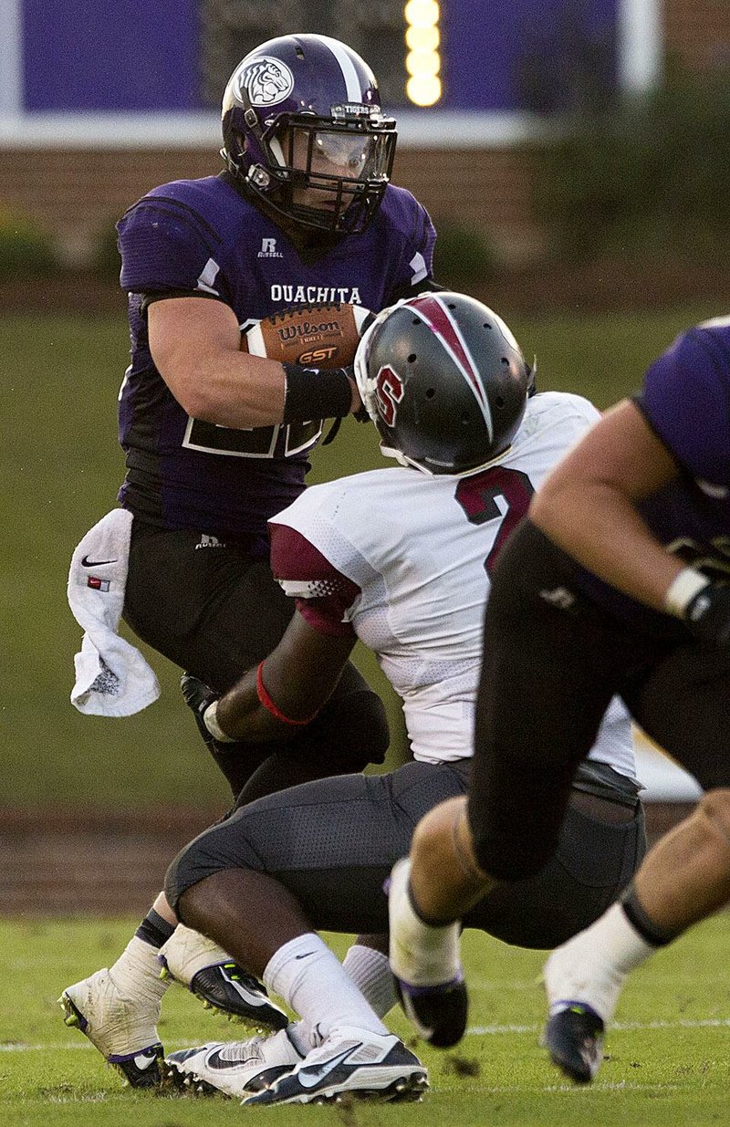 Arkansas Democrat-Gazette/MELISSA SUE GERRITS - 09/13/2014 - Ouchita Baptist's Steven Khener is taken down by Southern Nazarene's Larry Butler III during their game in Arkadelphia September 13, 2014. 