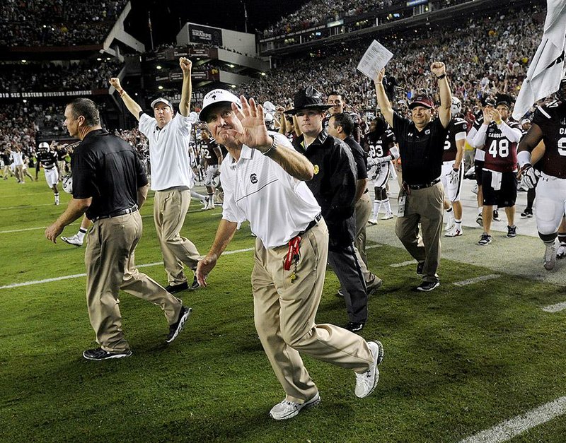 South Carolina head coach Steve Spurrier waves to fans after defeating Georgia 38-35 in an NCAA college football game on Saturday, Sept. 13, 2014, in Columbia, S.C. (AP Photo/Rainier Ehrhardt)