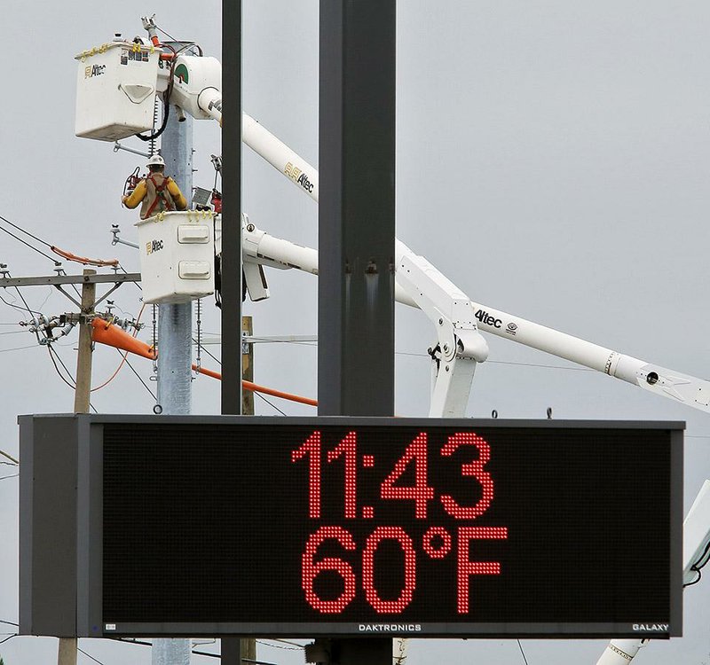 Arkansas Democrat-Gazette/JOHN SYKES JR. - Lower lunchtime temperatures made work much more comfortable for electrical workers at the intersection of Cantrell and Mississippi Friday morning.