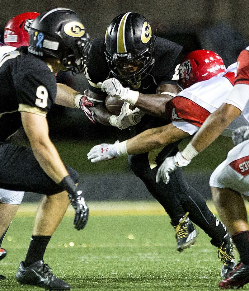 Little Rock Central’s Edward Robinson tries to break through the line of scrimmage during Friday night’s game against Fort Smith Northside at Quigley-Cox Stadium in Little Rock.