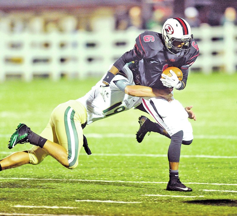  Staff Photo Michael Woods &#8226; @NWAMICHAELW Malcolm Neal of Springdale High tries to shake Alma defender Alex Beneux in the first half of Friday&#8217;s game against Alma at Jarrell Williams Bulldog Stadium in Springdale.