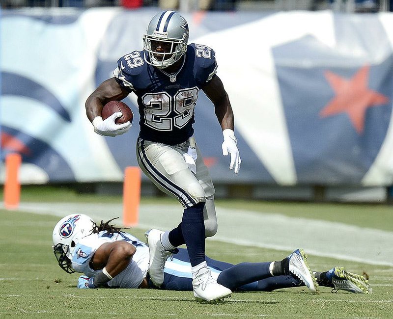 Dallas Cowboys running back DeMarco Murray (29) gets past Tennessee Titans safety Michael Griffin in the second quarter of an NFL football game Sunday, Sept. 14, 2014, in Nashville, Tenn. (AP Photo/Mark Zaleski)