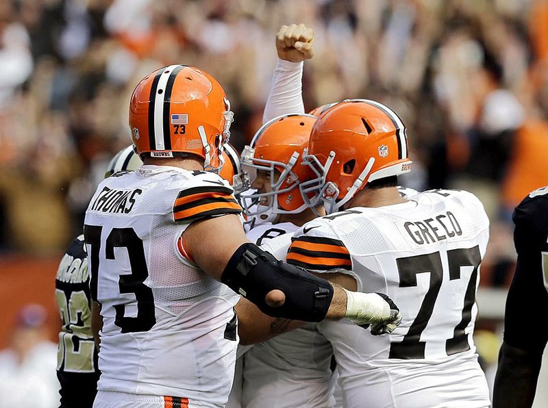 Cleveland Browns place kicker Billy Cundiff is mobbed by his teammates after kicking a 29-yard field goal with three seconds left to beat the New Orleans Saints 26-24 in an NFL football game Sunday, Sept. 14, 2014, in Cleveland. (AP Photo/Tony Dejak)