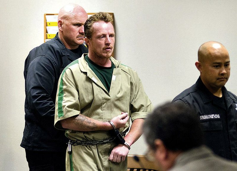 FILE - In this Aug. 11, 2014 file photo, Nicholas Sheley is escorted into the Whiteside County courtroom in Morrison, Ill., for sentencing in the murder of four people in a northwest Illinois apartment in the June 2008. Sheley who is serving life sentences for each of six summertime 2008 killings in Illinois next will face trial in Missouri on charges he killed an Arkansas couple during the spree. (AP Photo/The Telegraph, Alex T. Paschal, Pool, File)