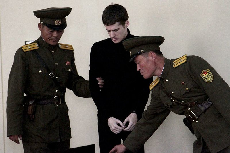 Handcuffed Matthew Miller, a U.S. citizen, is led to a courtroom for his trial at the Supreme Court in Pyongyang, North Korea, Sunday, Sept. 14, 2014. North Korea's Supreme Court on Sunday sentenced Miller to six years of hard labor for entering the country illegally and trying to commit espionage. (AP Photo/Kim Kwang Hyon)