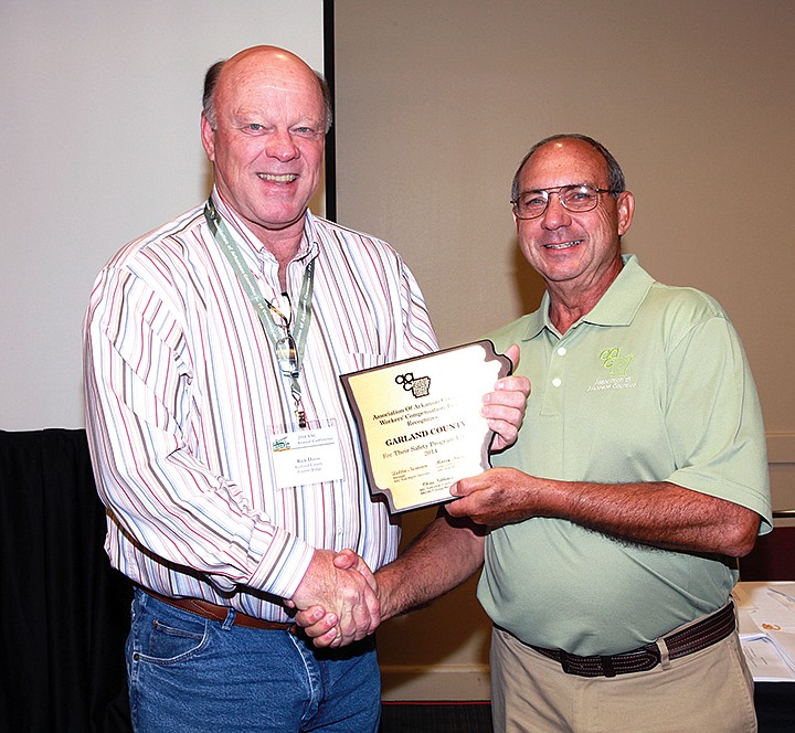 Submitted photo The Association of Arkansas Counties presented its annual safety awards during the AAC&#8217;s annual conference in Little Rock recently. Lee, Nevada, Pike, Desha and Searcy counties received the only five certificates in the state for no reportable injuries in 2013. Counties, including Garland, that were honored scored at least 80 percent on the AAC&#8217;s safety survey, had a loss ratio of less than 50 percent and had not been in the hazardous employer program during 2013 or 2014. Garland County Judge Rick M. Davis, left, accepted a 2014 safety award from AAC&#8217;s Barry Burkett.