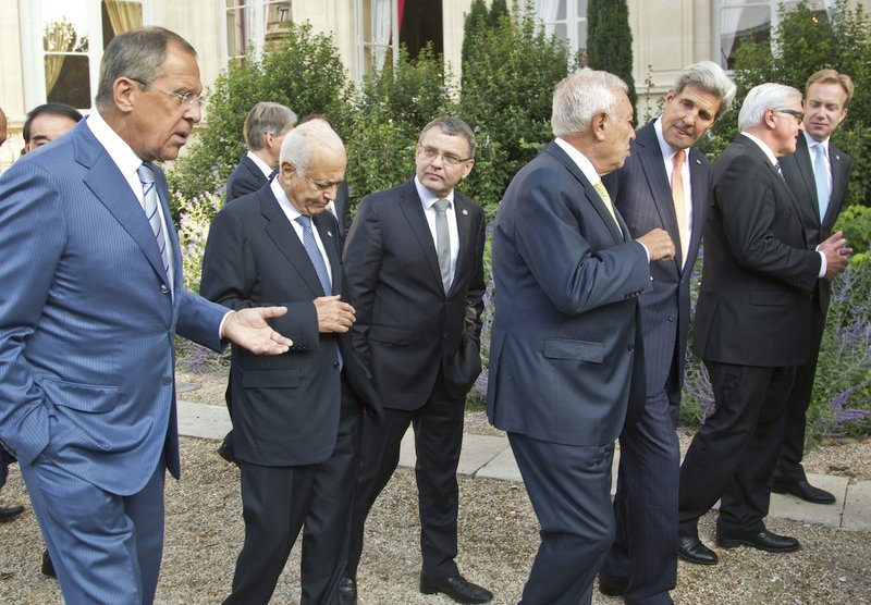 From left, Russian Foreign Minister Sergei Lavrov, Secretary General of the Arab League Nabil al Arabi, Czech Republic Foreign Minister Lubomir Zaoralek, Spanish Foreign Minister Jose Manuel Garcia-Margallo, U.S. Secretary of State John Kerry, German Foreign Minister Frank-Walter Steinmeier, Norwegian Foreign Minister Borge Brendem, walk back to the conference room after a group photo at the French Foreign ministry in Paris, Monday Sept. 15, 2014. Diplomats from around the world are in Paris pressing for a coherent global strategy to combat extremists from the Islamic State group. 