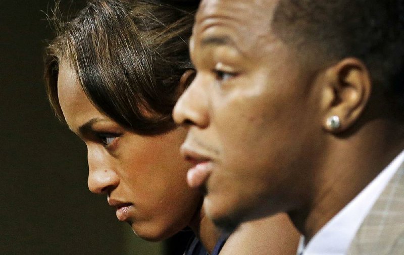 FILE - In this May 23, 2014, file photo, Janay Rice, left, looks on as her husband, Baltimore Ravens running back Ray Rice, speaks to the media during a news conference in Owings Mills, Md. A law enforcement official says he sent a video of Ray Rice punching his then-fiancee to an NFL executive five months ago, while league officers have insisted they didn't see the violent images until this week. The person played The Associated Press a 12-second voicemail from an NFL office number on April 9 confirming the video arrived. A female voice expresses thanks and says: "You're right. It's terrible." (AP Photo/Patrick Semansky, File)