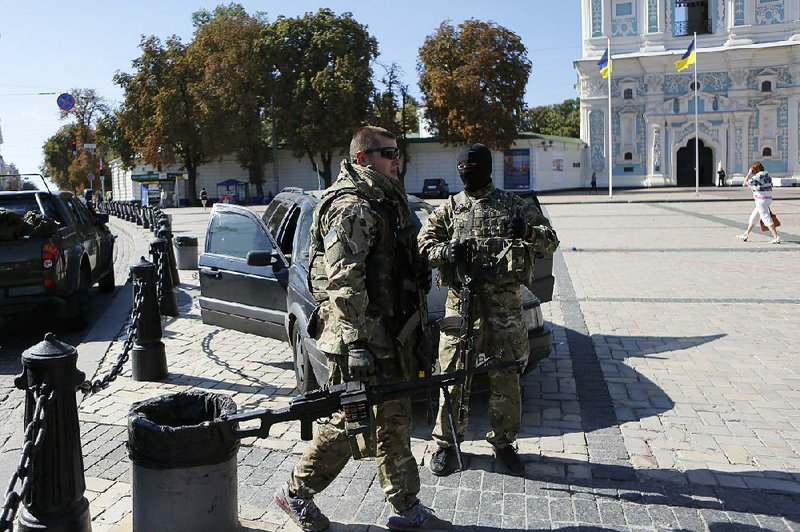 Fighters from the Azov volunteer battalion arrive on rotation from the front line in Kiev, Ukraine, Monday, Sept. 15, 2014. Shelling killed six people and wounded 15 others in the rebel stronghold of Donetsk, the city council said Monday — the worst reported violence since a cease-fire between Russian-backed rebels and Ukrainian troops took effect on Sept. 5. (AP Photo/Sergei Chuzavkov)