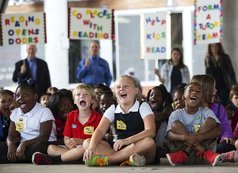 Arkansas Democrat-Gazette/MELISSA SUE GERRITS - 09/15/2014 - School kids listen to speakers encouraging reading and the AR Kids Read program during a rally at the River Market Pavillion September 15, 2014. AR Kids Read is a community service strategy which seeks volunteers to help children attain reading level proficiency by the beginning of the fourth grade. 