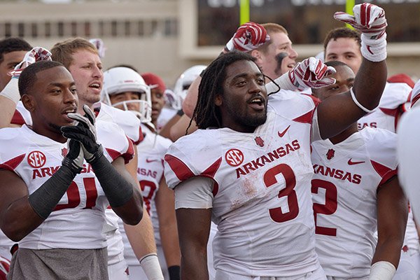 Arkansas running back Alex Collins (3) and other players celebrate after defeating Texas Tech in Jones AT&T Stadium in Lubbock, Texas on Saturday Sept. 13, 2014. 