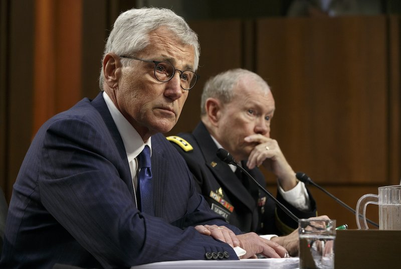 Defense Secretary Chuck Hagel, left, and Army Gen. Martin Dempsey, chairman of the Joint Chiefs of Staff, appear before the Senate Armed Services Committee, the first in a series of high-profile Capitol Hill hearings that will measure the president's ability to rally congressional support for President Barack Obama's strategy to combat Islamic State extremists in Iraq and Syria, in Washington, Tuesday, Sept. 16, 2014. Obama last week outlined his military plan to destroy the extremists, authorizing U.S. airstrikes inside Syria, stepping up attacks in Iraq and deploying additional American troops, with more than 1,000 now advising and assisting Iraqi security forces to counter the terrorism threat. 