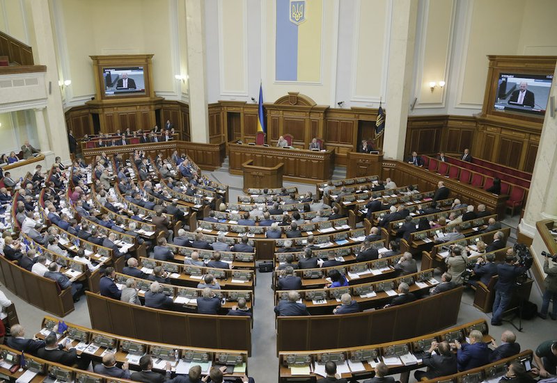 Ukrainian lawmakers look at a TV screens as the European Union ratified an agreement to deepen economic and political ties with the Ukraine in Kiev, Ukraine, on Tuesday, Sept. 16, 2014. Ukraine's parliament ratified an agreement to deepen economic and political ties with the European Union on Tuesday, and passed legislation to grant autonomy to the rebellious east as part of a peace deal. 