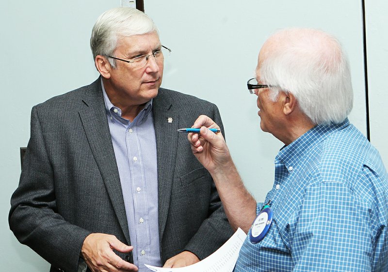 The Sentinel-Record/Richard Rasmussen Community involvement: Visit Hot Springs CEO Steve Arrison, left, talks with Oaklawn Rotary Club member Clyde Covington before the club's weekly meeting on Monday. Arrison talked to the club about new things happening with the city's tourism industry and how members can involve the community in that progress.