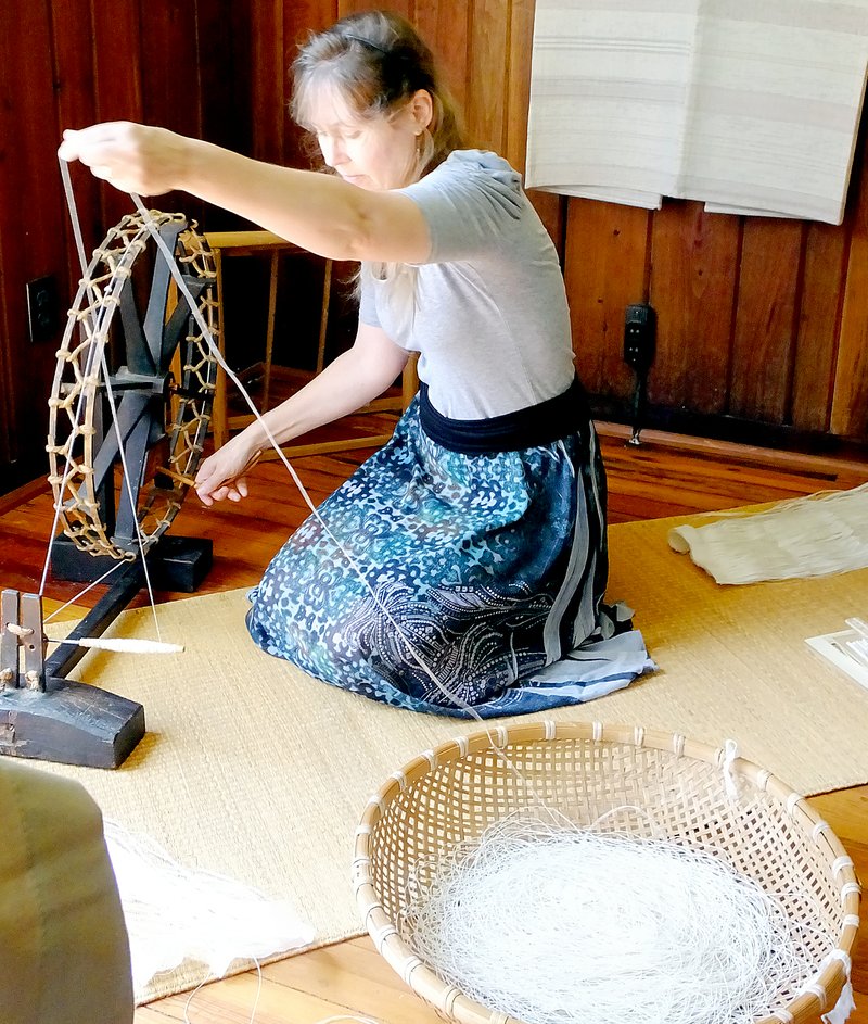 Lynn Atkins/The Weekly Vista Susan Byrd uses a Japanese spinning wheel to twist long, narrow strips of paper into thread that can be woven into shifu, a traditional Japanese fabric that is actually made of paper.