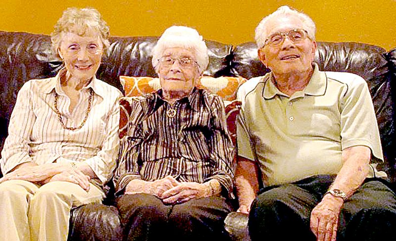 Submitted Dianne and Bill Dawkins of Bella Vista sits on either side of his mother, Naomi, at her 100th birthday party Sept. 9 in Springdale.