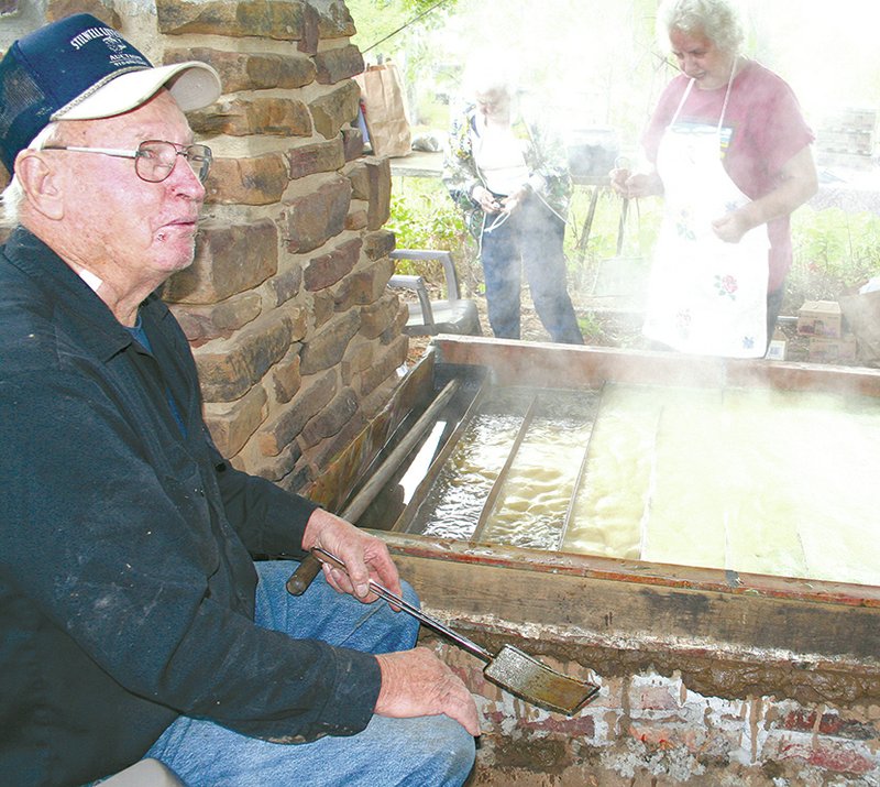 File Photo Leonard Reed, a descendant of one of Cane Hill&#8217;s earliest families, attended the 2011 Cane Hill Harvest Festival and watched over a large copper vat of sorghum cane juice which was cooked over hot coals until it was ready as sorghum molasses.