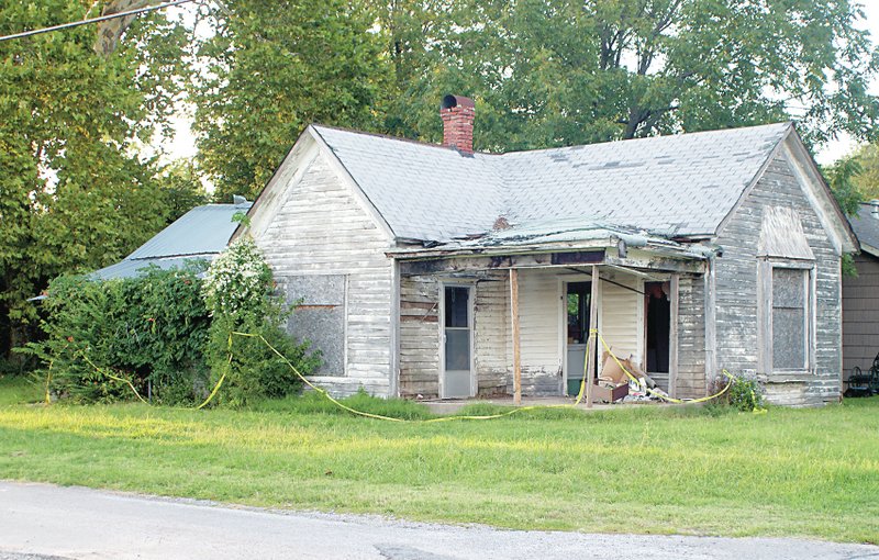 Photo by Randy Moll Demolition was approved for this old house and for another on West Main Street by the city council on Sept. 8. This property, on N. Rust, was donated to the city and is expected to be used for parking and a pocket park. The property on West Main Street was damaged by fire and is being condemned by the city.