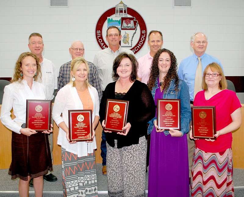 Janelle Jessen/Herald-Leader Teachers of the year for the Siloam Springs School District were announced at Thursday&#8217;s school board meeting. Principals and school adopter presidents presented each teacher with a plaque and told why they were chosen for the honor. Pictured on the front row are Katie Bergthold, Northside Elementary School teacher of the year; Michele Jackson, Siloam Springs High School teacher of the year; Julie Stewart, Siloam Springs Intermediate School teacher of the year; Rebecca Evans, Southside Elementary School teacher of the year; and Jill Hartman, Allen Elementary School teacher of the year. Not pictured is Kelly Allison, Siloam Springs Middle School teacher of the year. On the back row are school board members Brian Lamb, Louie Thomas, Brent Butler and Roger Holroyd and superintendent Ken Ramey.