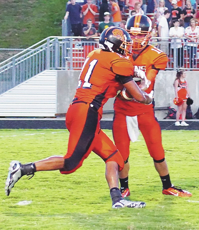 File Photo by Randy Moll Gravette&#8217;s Cedric Duarte receives a handoff from quarterback Bryce Moorman during play in Gravette earlier this month.