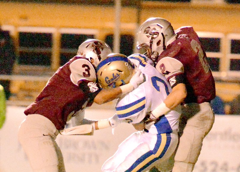 Bud Sullins/Special to the Herald-Leader Siloam Springs safeties Matt Downing, left, and Coby Roach, right, converge on a tackle of Harrison&#8217;s Kanon Kirkland during last week&#8217;s game at Glenn W. Black Stadium.