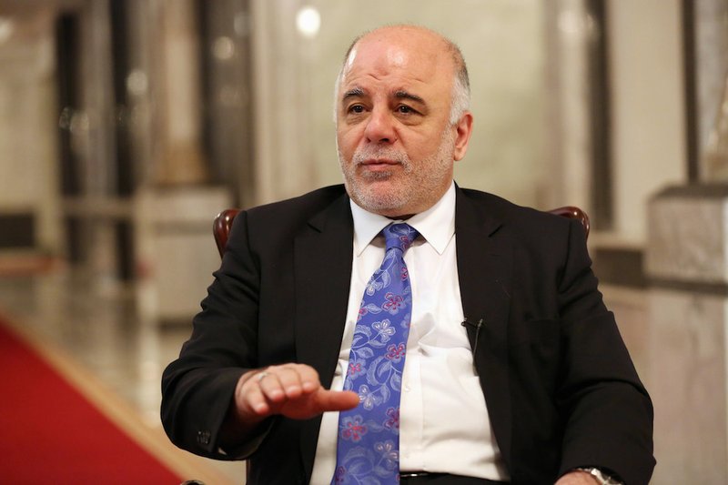 Iraq's Prime Minister Haider al-Abadi speaks during an interview with The Associated Press in Baghdad, Iraq, on Wednesday, Sept. 17, 2014. Iraq’s new prime minister says foreign ground troops are neither necessary nor wanted in his country’s fight against the Islamic State group. 