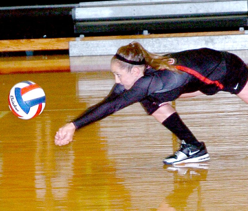 RICK PECK MCDONALD COUNTY PRESS McDonald County&#8217;s Destiny Arnall dives for a ball in the Lady Mustangs&#8217; 25-19, 25-16 win over Cassville Monday night at MCHS.