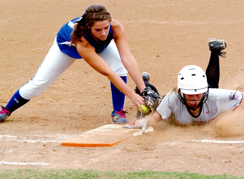 RICK PECK MCDONALD COUNTY PRESS McDonald County&#8217;s Hanna Schmit dives back to first base to beat a tag during the Lady Mustangs&#8217; 5-4 win Sept. 11 at MCHS.