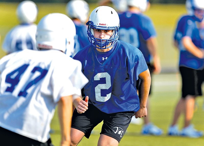  STAFF PHOTO JASON IVESTER Brett Hauser, Rogers High defensive back, practices Aug. 4 at Whitey Smith Stadium.