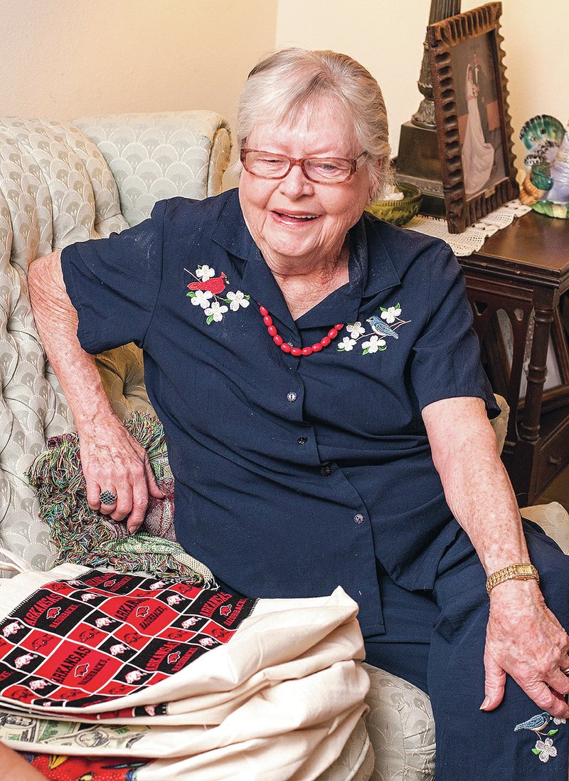 STAFF PHOTO ANTHONY REYES &#8226; @NWATONYR Elsie Sherry talks Friday about the tote bags she makes in her home in Springdale. Sherry gives away all the bags to friends and strangers. She also attaches a Bible verse to each bag.