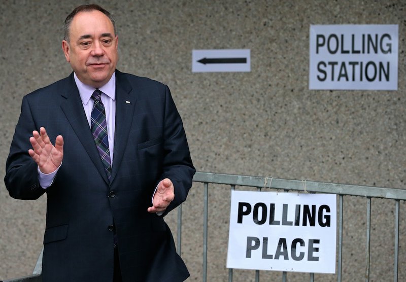 Scotland's First Minister Alex Salmond poses for photographs after casting his ballot at Ritchie Hall in Strichen, Scotland, on Thursday, Sept. 18, 2014. Polls opened across Scotland in a referendum that will decide whether the country leaves its 307-year-old union with England and becomes an independent state. 