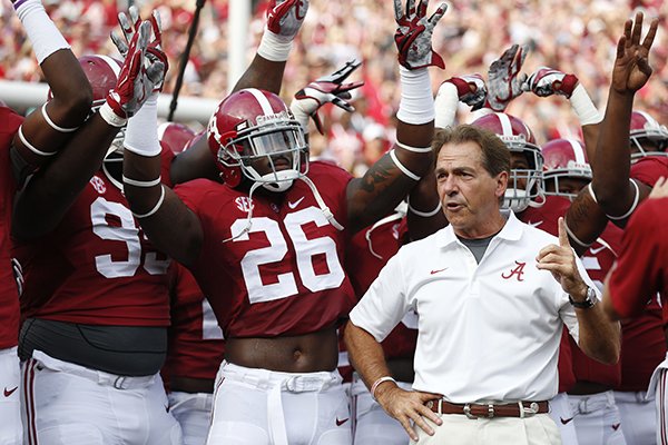 Alabama head coach Nick Saban stands with his team before they play Southern Mississippi before an NCAA college football game on Saturday, Sept. 13, 2014, in Tuscaloosa, Ala. (AP Photo/Brynn Anderson)