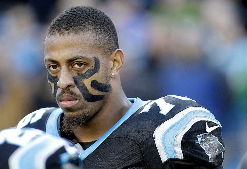 In this Dec. 15, 2013, file photo, Carolina Panthers' Greg Hardy watches before an NFL football game against the New York Jets in Charlotte, N.C. The Panthers announced Wednesday, Sept. 17, 2014, that they've placed Hardy on the exempt-commissioner's permission list, meaning the Pro Bowl defensive end has been removed from the team's active roster until his domestic violence case is resolved. 