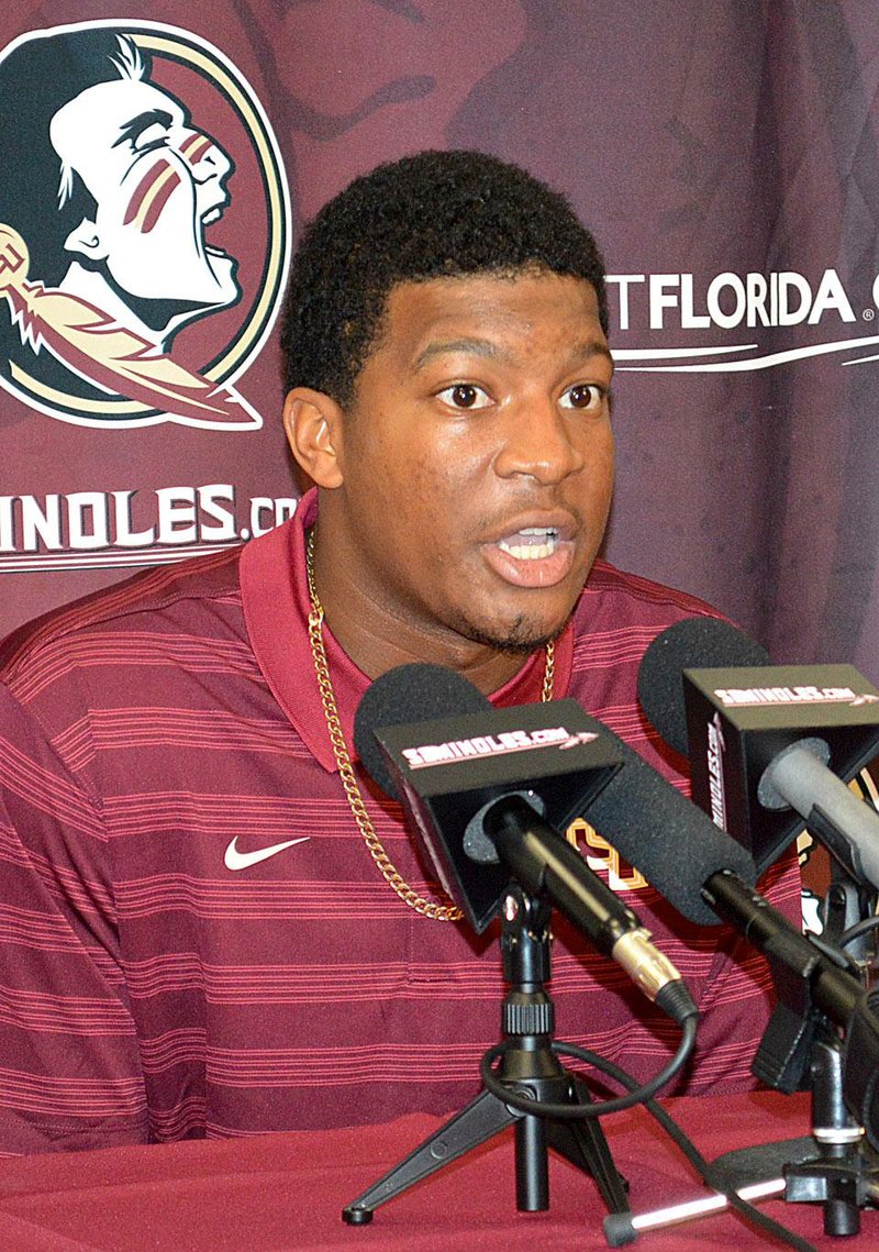 Florida State quarterback Jameis Winston comments on his half-game suspension Wednesday, Sept. 17, 2014,  during a news conference at Florida State University in Tallahassee, Fla. The 2013 Heisman Trophy winner apologized for leaping on a table and shouting obscenities on campus. The university benched him for the first half of Saturday's game against Clemson. (AP Photo/Tallahassee Democrat,  Bill Cotterell)  NO SALES