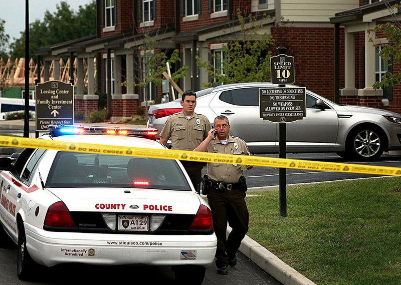 St. Louis County police officers investigate the scene of a fatal police officer involved shooting on Thursday, Sept. 18, 2014 in Jennings, Mo.  St. Louis County Police Chief Jon Belmar said the officers fired a combined 25 shots at the suspect. The officers told Belmar the suspect tried to fire at them, but the rifle the suspect had,  jammed. No casings from the suspect's .22-caliber rifle were found. This is the second fatal shooting of a black suspect by police in the region since the fatal August shooting of Michael Brown by a Ferguson, Mo.,  officer.  (AP Photo/St. Louis Post-Dispatch, David Carson)  EDWARDSVILLE INTELLIGENCER OUT; THE ALTON TELEGRAPH OUT