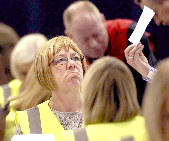 Officials check ballot papers as counting continues in the Scottish Independence Referendum at the Royal Highland Centre in Edinburgh, Scotland, Friday, Sept. 19, 2014. From the capital of Edinburgh to the far-flung Shetland Islands, Scots embraced a historic moment - and the rest of the United Kingdom held its breath - after voters turned out in unprecedented numbers for an independence referendum that could end the country's 307-year union with England. (AP Photo/David Cheskin)