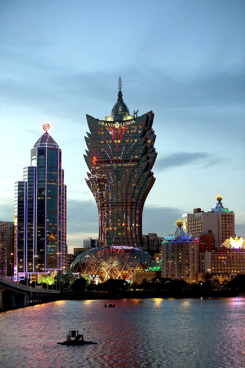 The Bank of China Ltd. building, left, Casino Grand Lisboa and Casino Lisboa, both operated by SJM Holdings Ltd., in Macau. Chinaís high-spending gamblers are looking to bet outside Macau amid a government assault on corruption and extravagance, and thatís boosting casinos from the Philippines to the Las Vegas Strip. Illustrates CHINA-GAMBLERS (category f) by Vinicy Chan (c) 2014, Bloomberg News. Moved Wednesday, Sept. 17, 2014 (MUST CREDIT: Bloomberg News photo by Brent Lewin).