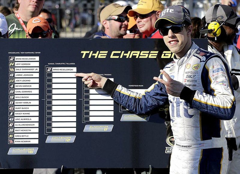 Brad Keselowski (2) celebrates as he points his name to the second round of the Chase by winning the opener at Chicagoland Speedway in Joliet, Ill., Sunday, Sept. 14, 2014. (AP Photo/Nam Y. Huh)