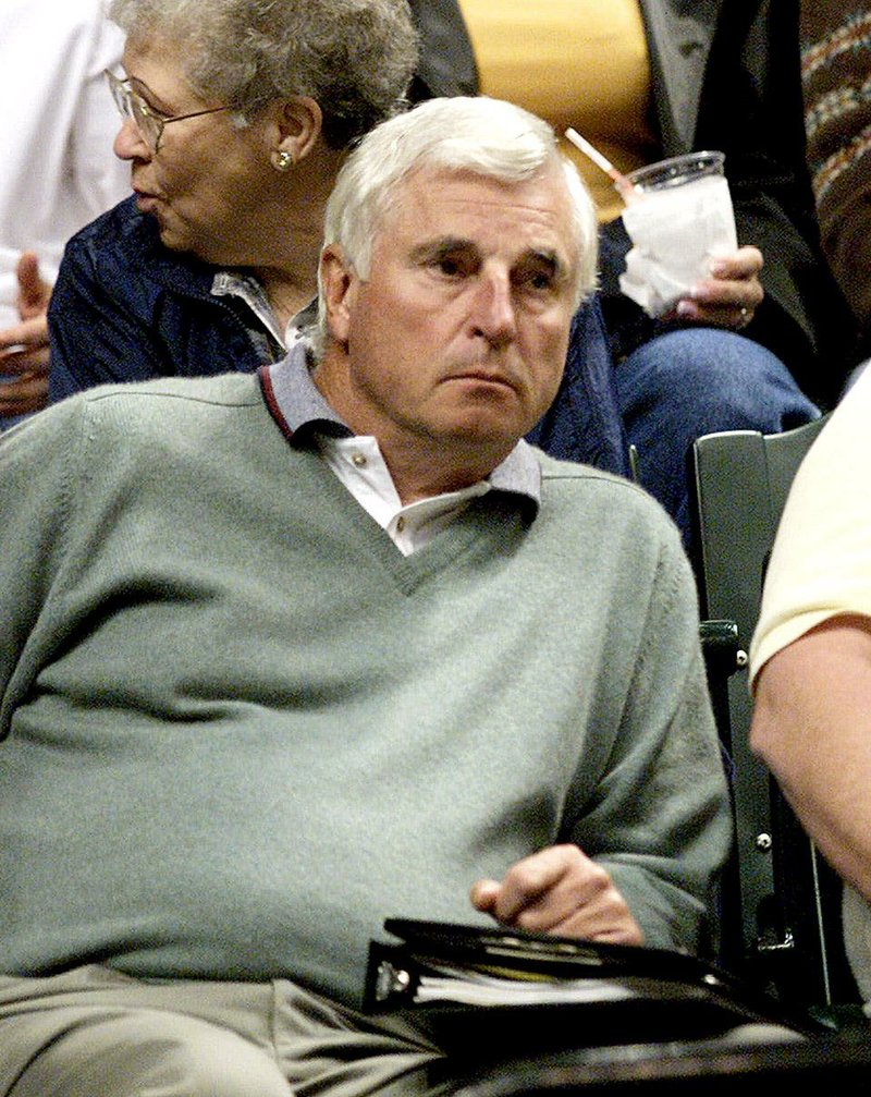 Former Indiana University basketball coach Bobby Knight keeps an eye on the Milwaukee Bucks-Indiana Pacers game in Indianapolis, Wednesday, Nov. 8, 2000. Knight attended the Pacers' practice on Tuesday to talk about the team's offense. (AP Photo/John Harrell)