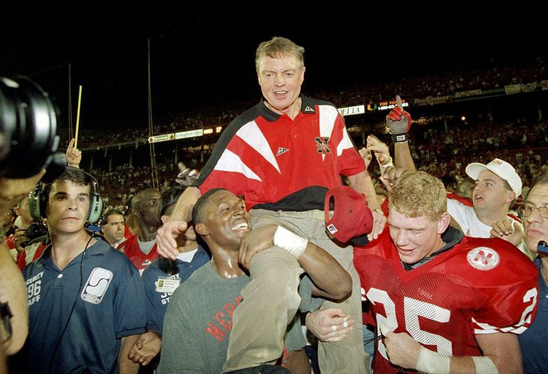 FILE - In this Jan. 1, 1995, file photo, Nebraska players carry coach Tom Osborne off the field after the Huskers defeated Miami 24-17 in the Orange Bowl NCAA college football game in Miami. The Miami and Nebraska programs are but a shell of their former selves as they enter Saturday night's game in Lincoln. (AP Photo/Doug Mills, File)